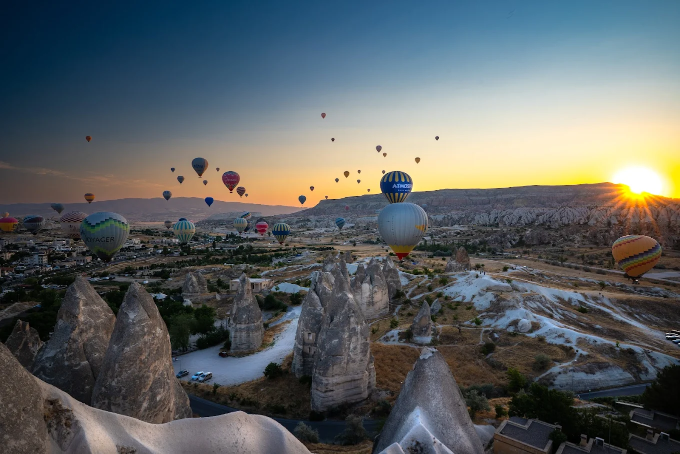 Multiple hot air balloons at sunrise in Cappadocia over Goreme valleys-Cappadocia panoramic viewpoint after balloon flight and Red Tour combo