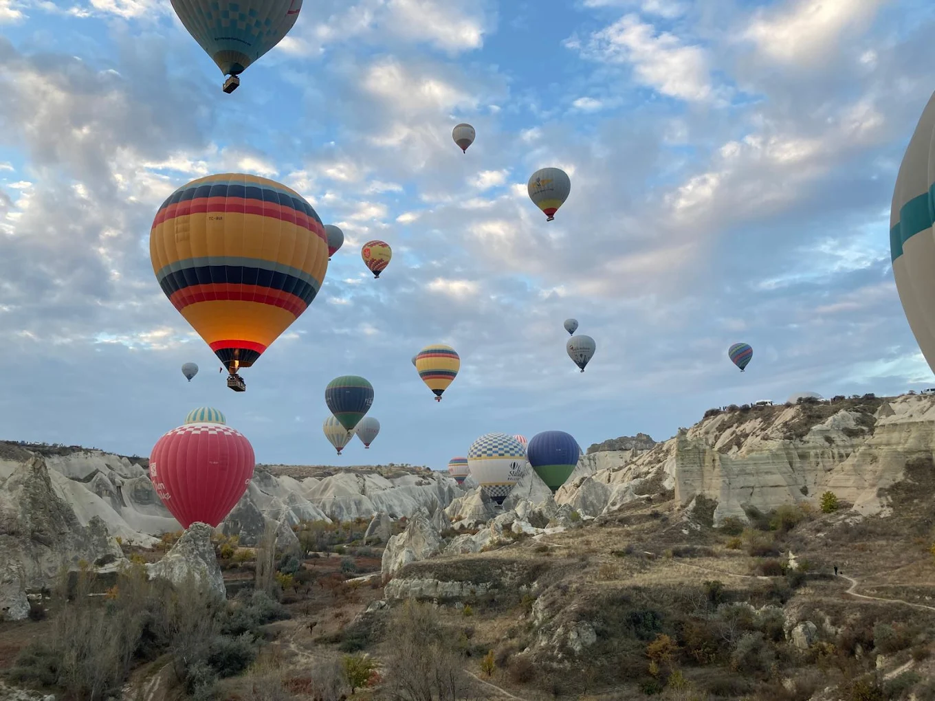 Cappadocia hot air balloon ride at sunrise over fairy chimneys with panoramic valley views